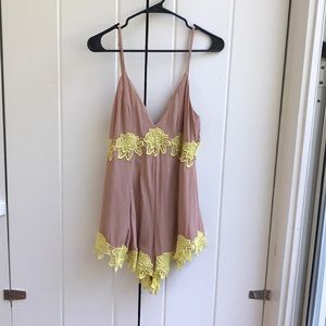 Tan romper with delicate yellow lace detail
